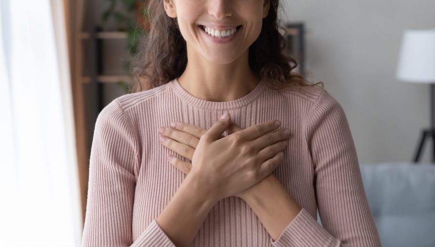 Close,Up,Focus,On,Happy,Sincere,Female,Holding,Folded,Hands