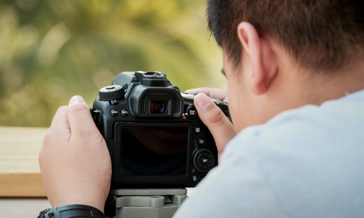 Young,Asian,Photographer,Working,Camera,Set,Video,Or,Take,Photo